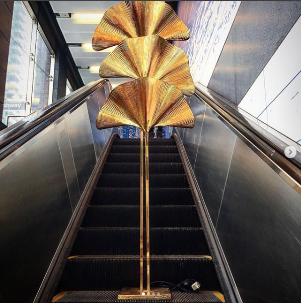 Tommaso Barbi Carlo Giorgi Italian design 1970's ginkgo leah floor lamp on an escalator in New York City