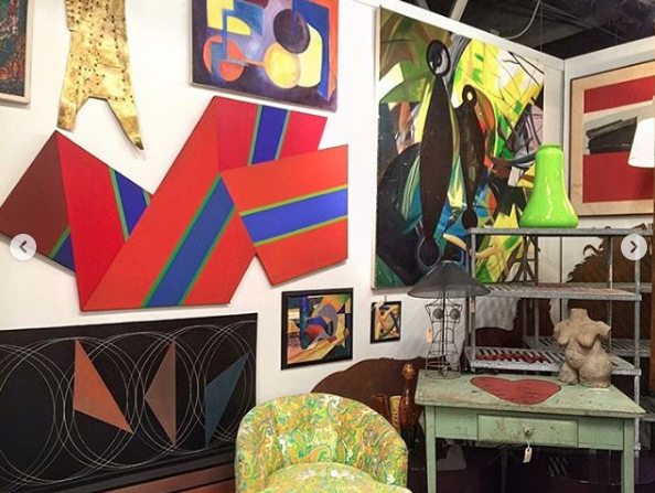 Heather Karlie Vieira at the Antique and Design Center during High Point Furniture Market with the 20th Century abstract shaped canvas by Canadian artist Reginald Holmes painitng